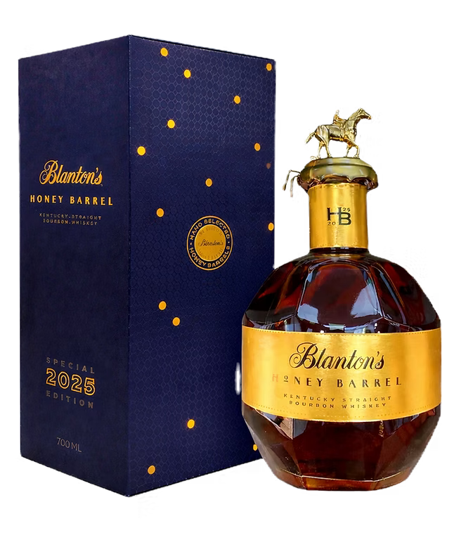 A bottle of Blanton's Honey Barrel Bourbon 2025 Special Release 700mL with a gold label and horse stopper sits next to its blue and gold special edition box.