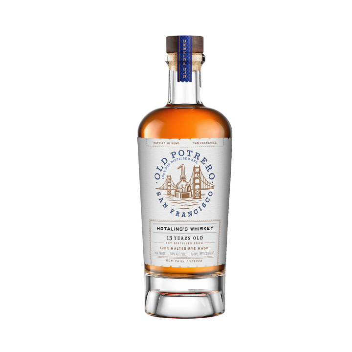 A bottle of Old Potrero Hotaling's Bottle in Bond 13 Year Old Whiskey from Old Potrero Whiskey, featuring a white label with a building illustration, gold cap, blue accents, and rich amber whiskey inside.