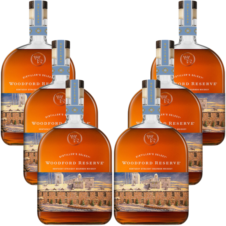 Six bottles of Woodford Reserve Bourbon Holiday Edition 2026 750ml are arranged in two rows of three, displaying their rich golden-brown liquid and festive labels.