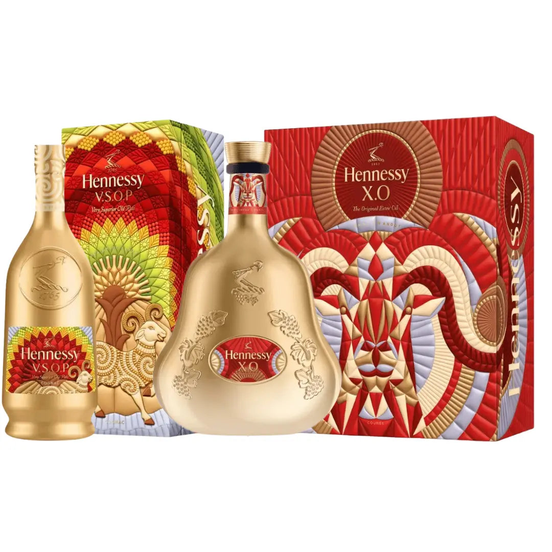 Two gold Hennessy Lunar New Year 2027 Year of the Goat V.S.O.P &amp; X.O Cognac bottles displayed in front of their respective decorative boxes featuring illustrations of goats.