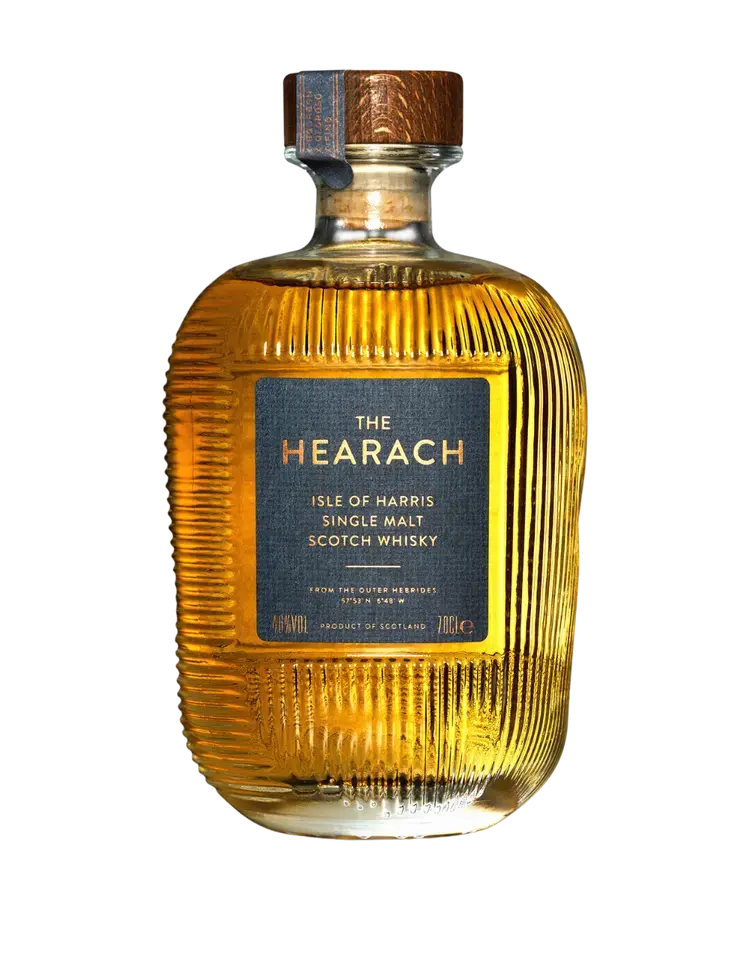 A bottle of The Hearach Isle of Harris Single Malt Scotch Whisky by The Hearach, featuring a ribbed glass design and a blue and copper label.