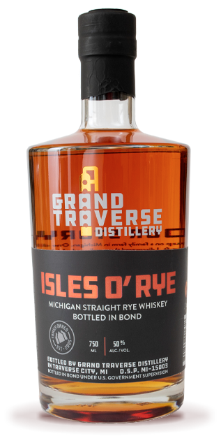 A bottle of Grand Traverse Distillery Isles O' Rye Bottled in Bond Michigan Straight Rye Whiskey, with a black and orange label displaying white text, bottling details, and distillery info on a plain white background.