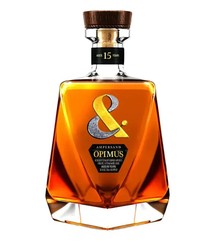 A bottle of Ampersand Optimus 15 Year Old Bourbon Finished in Tokaji Casks, with a brown liquid, gold ampersand symbol, wooden cap, and geometric shape, reflects the elegance of premium bourbon.
