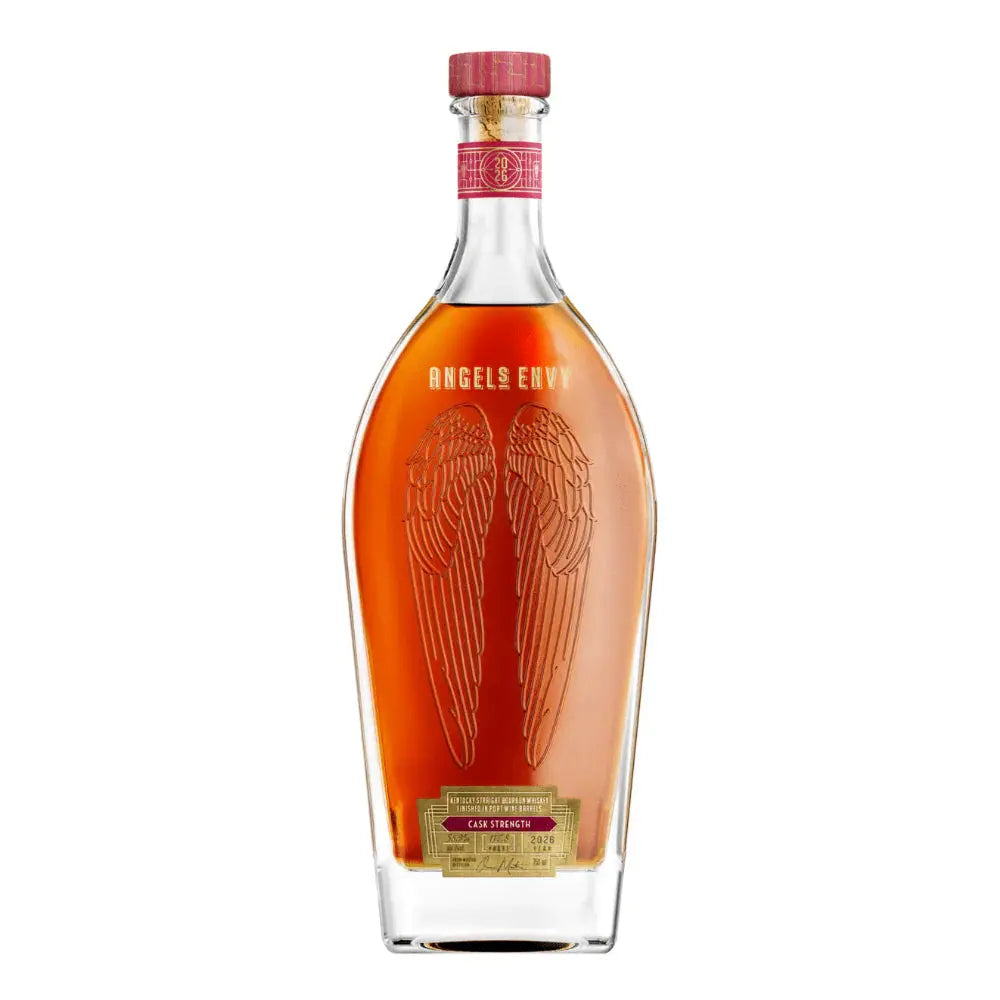 A clear glass bottle of Angel’s Envy 10 Year Cask Strength Bourbon 2026, featuring embossed angel wings, a red cap, and gold detailing.