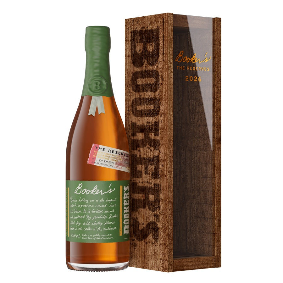 A bottle of Booker’s The Reserves 2026 Batch Kentucky Straight Rye Whiskey with a green label stands next to a tall wooden display box labeled “Booker’s The Reserves 2026 Batch,” showcasing this limited edition rye whiskey from Booker’s.