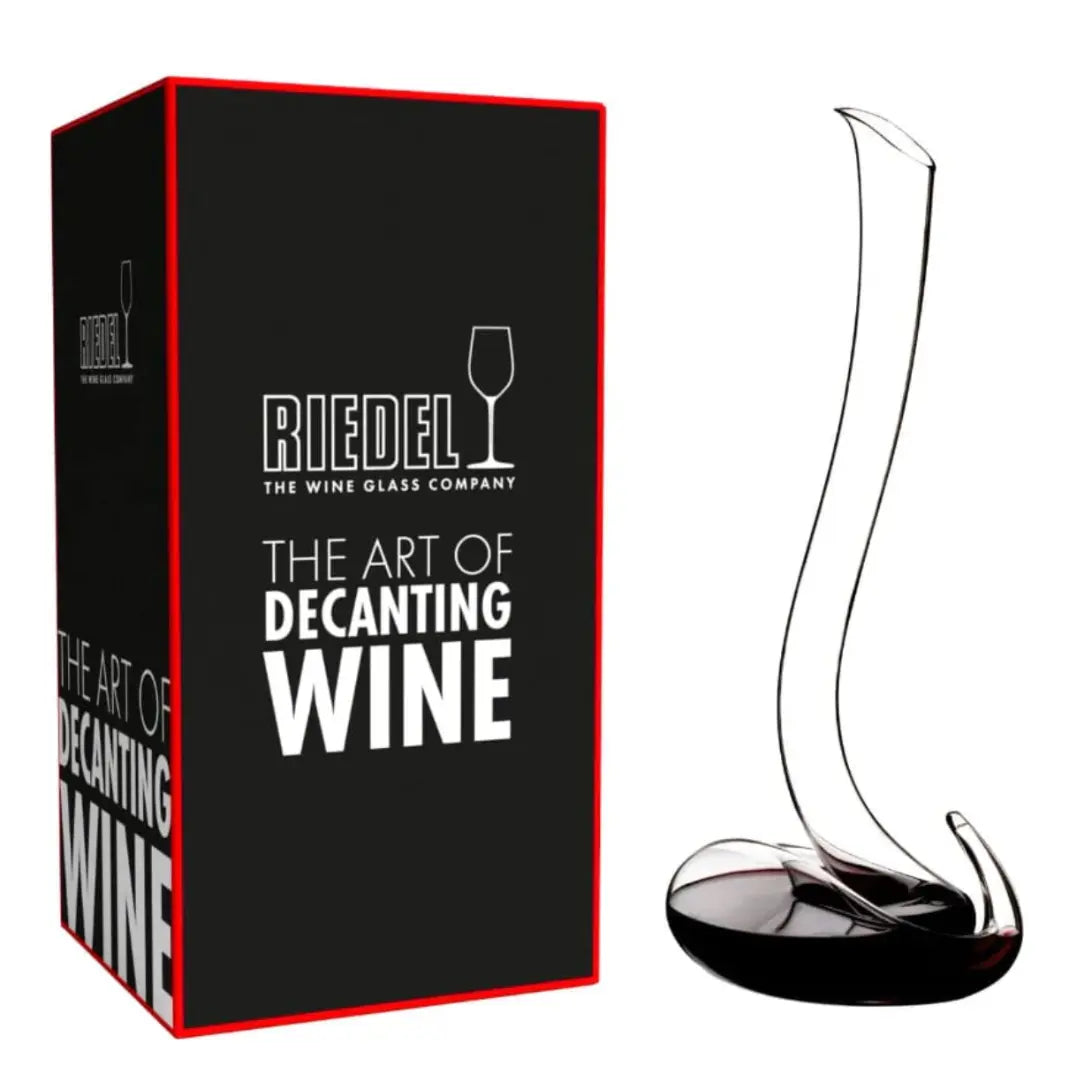 A Riedel Wine Decanter Eve with a tall, elegantly curved neck sits beside its black and red box labeled "Riedel: The Art of Decanting Wine," exemplifying the exceptional wine aeration achieved by this exquisite crystal decanter from Riedel.