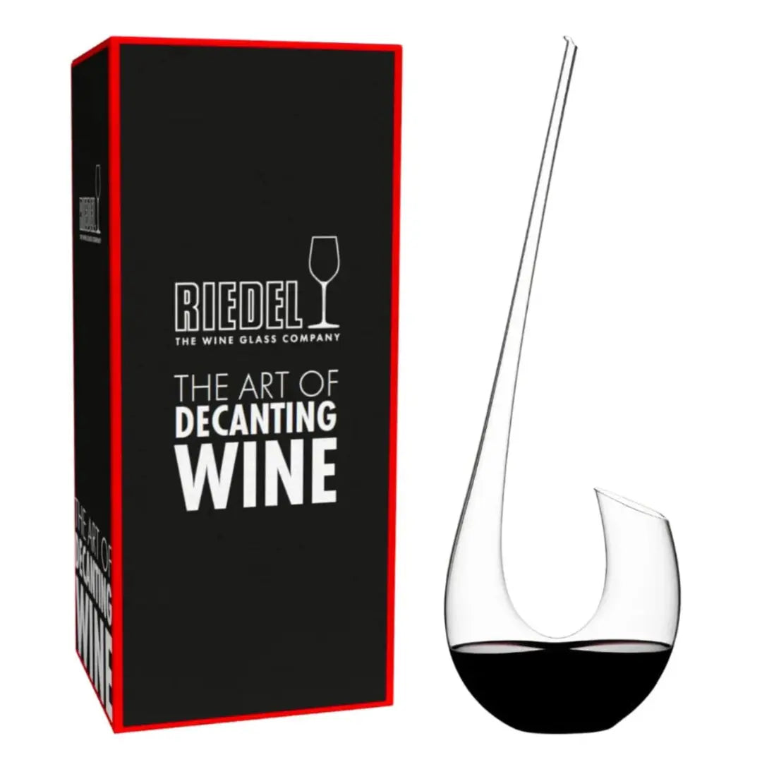 Displayed alongside its sleek black box bearing the phrase "Riedel The Art of Decanting Wine" in white lettering, the RIEDEL Wine Decanter Swan by Riedel features a graceful, curved crystal design that enhances wine aeration and brings an air of sophistication to any table setting.