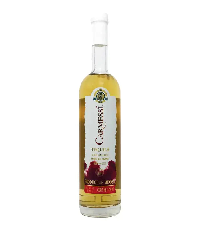 A 750mL bottle of Carmessi Reposado Tequila features a clear label, golden tequila, and striking red agave designs at the base. Crafted from 100% de agave and proudly labeled as a Product of Mexico, this smooth reposado comes from the Carmessi brand.