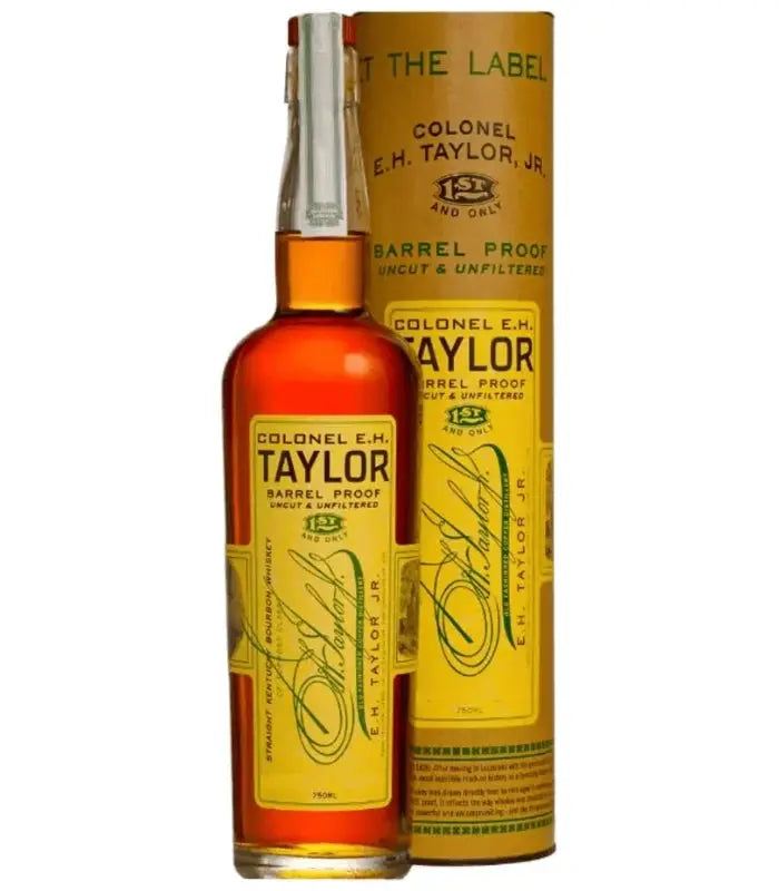 A bottle of Colonel E.H. Taylor, Jr. Barrel Proof Bourbon Batch 15 stands in front of its matching yellow cylindrical box, both adorned with black and gold text and signature-style writing—a striking presentation worthy of the Colonel E.H. Taylor name.