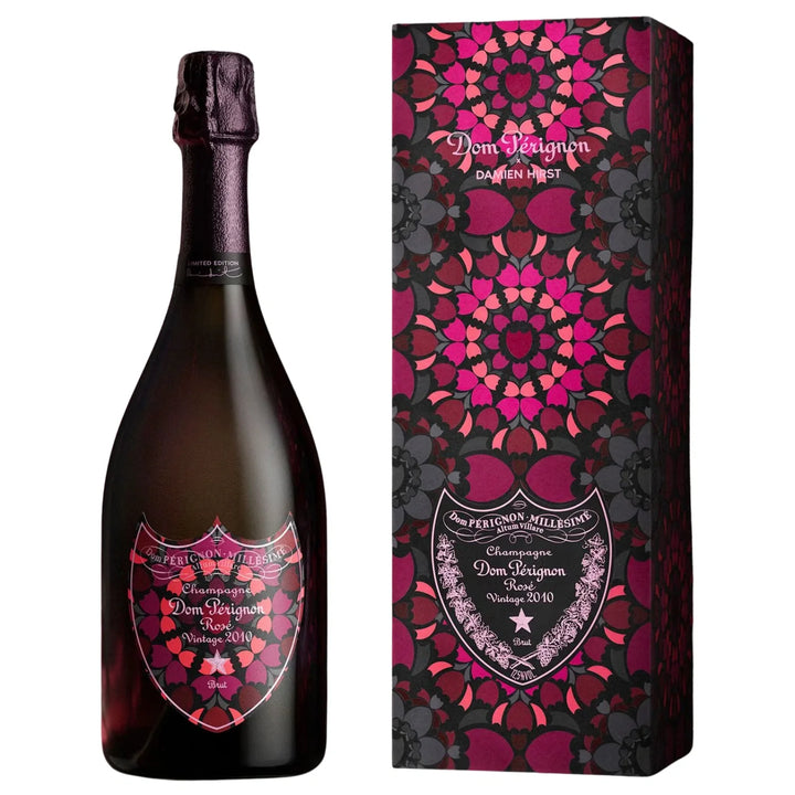 Dom Pérignon Rosé Vintage 2010 Damien Hirst Limited Edition bottle and its matching rectangular gift box, both featuring a dark, kaleidoscopic floral pattern on their labels and packaging.