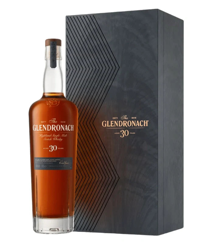 A bottle of Glendronach 30 Year Old Single Malt Scotch Whisky 700ml stands beside its sleek, dark box with gold and white lettering, reflecting the brand’s tradition of exquisite sherry cask maturation.