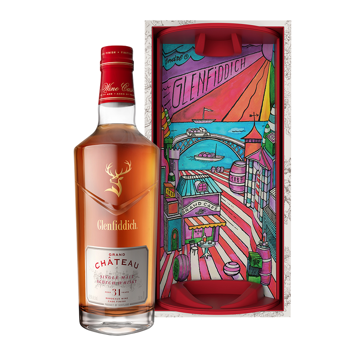 A bottle of Glenfiddich 31 Year Old Grand Chateau Bordeaux Wine Cask Finish stands beside a vibrant, illustrated gift box with a cityscape design and the Glenfiddich logo at the top.