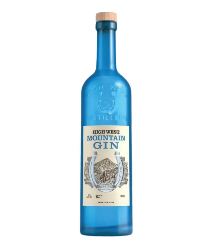 A 750ml blue glass bottle of High West Mountain Gin by High West Distillery, an American gin with 46% ABV, a wooden cap, and a cream label featuring horseshoe and mountain artwork.