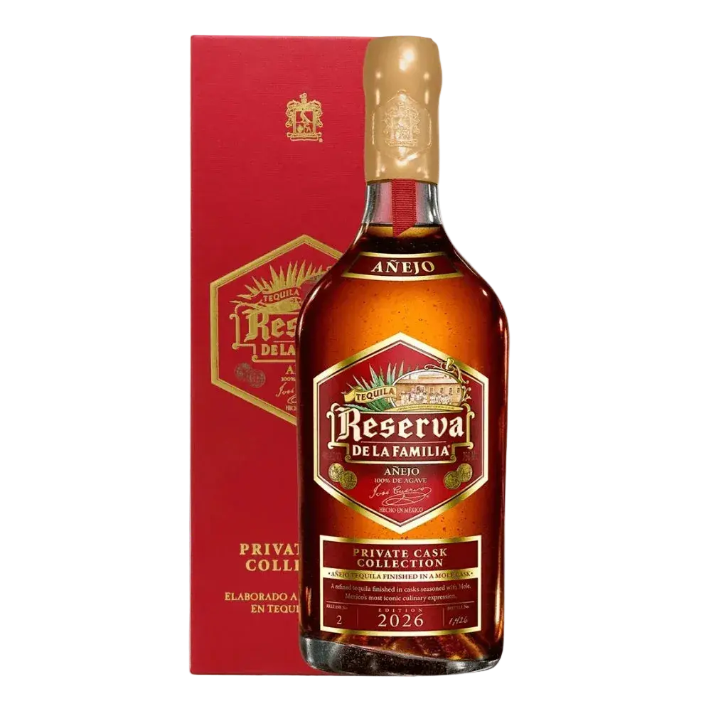 A bottle of Jose Cuervo Reserva de la Familia Private Cask Collection Añejo 2026 tequila in front of its matching red display box.