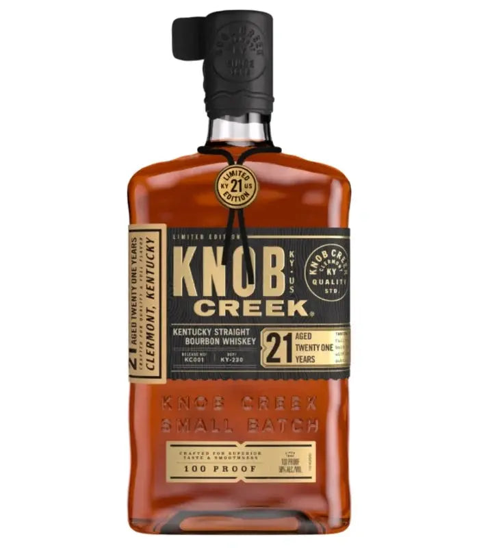 A square bottle of Knob Creek 21 Year Limited Edition Kentucky Straight Bourbon Whiskey with a black wax seal on the cap and a tan label stating 21 years and 100 proof.