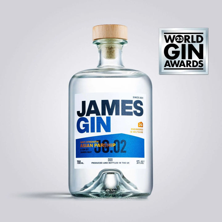 A clear bottle of James Gin Navy Strength 700mL 114 Proof, with a wooden cap and blue, orange, and white label, stands next to a silver World Gin Awards 2023 badge. Includes a souvenir gift key chain.