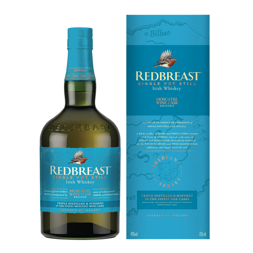 A bottle of Redbreast Moscatel Wine Cask Edition Irish Whiskey stands next to its blue box packaging, adorned with gold accents and detailed product information.