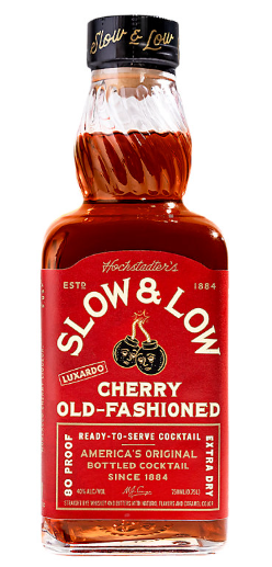 A bottle of Slow & Low Luxardo Cherry Old Fashioned Extra Dry, featuring a red label with gold and white text and cherry imagery.