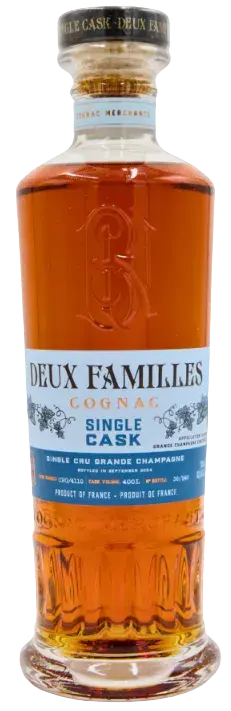 A clear glass bottle of Deux Familles Single Cask Grande Champagne Cognac filled with amber-colored liquid, featuring a light blue label with the text Single Cask.