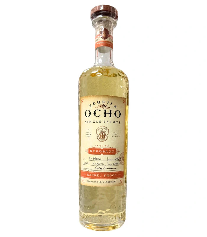 A tall, clear 750mL bottle of Ocho Tequila’s Tequila Ocho Reposado Barrel Proof La Mesa 2025 Single Estate features a beige and orange label with barrel proof details. The tequila inside shows a light golden hue.