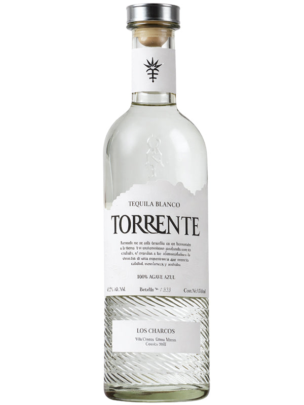 Torrente Blanco Tequila is a clear glass bottle with a white label, black text, and wooden cork. Made from 100% Blue Weber agave, it contains 47% alc/vol and is crafted in Los Charcos, Mexico by Torrente.