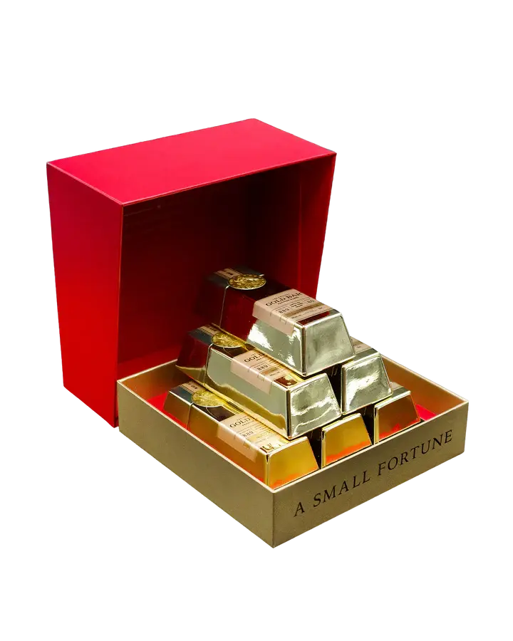 An open Gold Bar Small Fortune Gift Set from Main Street Liquor reveals stacked, individually wrapped chocolate bars, inspired by mini whiskey bottles and treasures aged in Napa wine barrel-finished style.