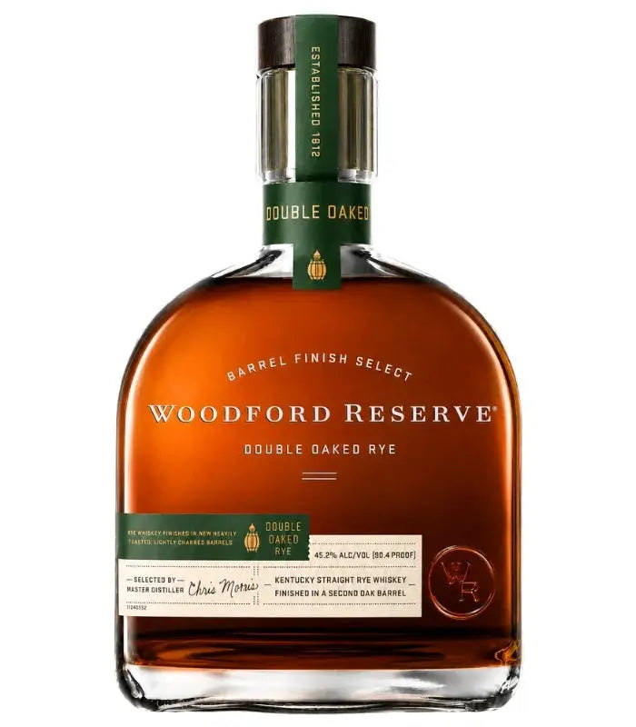 A bottle of Woodford Reserve Double Oaked Rye Barrel Finish Select (Pre-Order) Kentucky straight rye whiskey from Woodford Reserve, featuring a brown liquid, a green cap, and a label highlighting its double barrel finish and selection by master distiller Chris Morris.