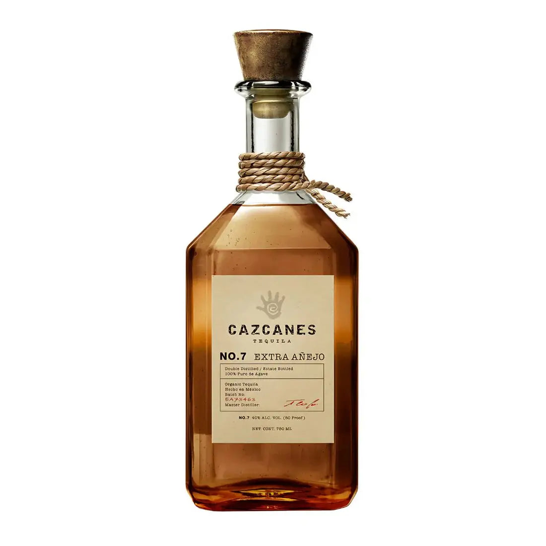 A clear glass bottle of Cazcanes No. 9 Extra Anejo Tequila by Cazcanes Tequila, made from 100% Weber Blue Agave, with a wooden cork, rope around the neck, amber liquid inside, and a cream label with black and gold text.