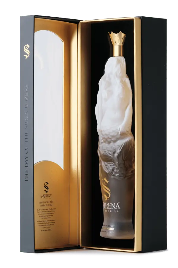 Día De La Sirena Reposado Tequila presented in a frosted glass mermaid-shaped bottle inside a luxurious gift box.