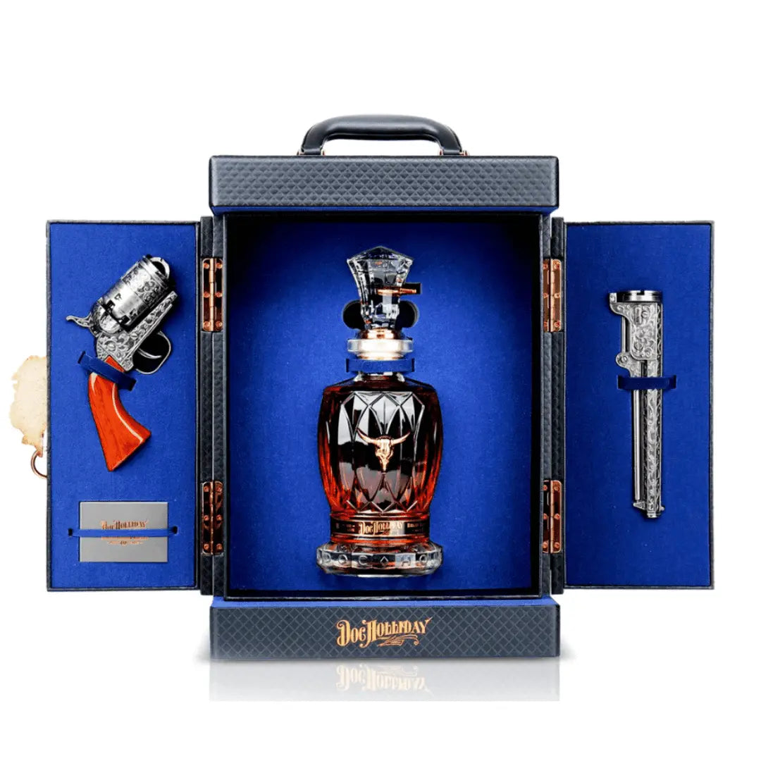 The Doc Holliday 10-Year Bourbon Revolver Set features a luxury decanter in a blue velvet-lined box with an ornate revolver replica and engraved metal piece, perfect for collectors. The “Doc Holliday” brand is inscribed at the bottom.