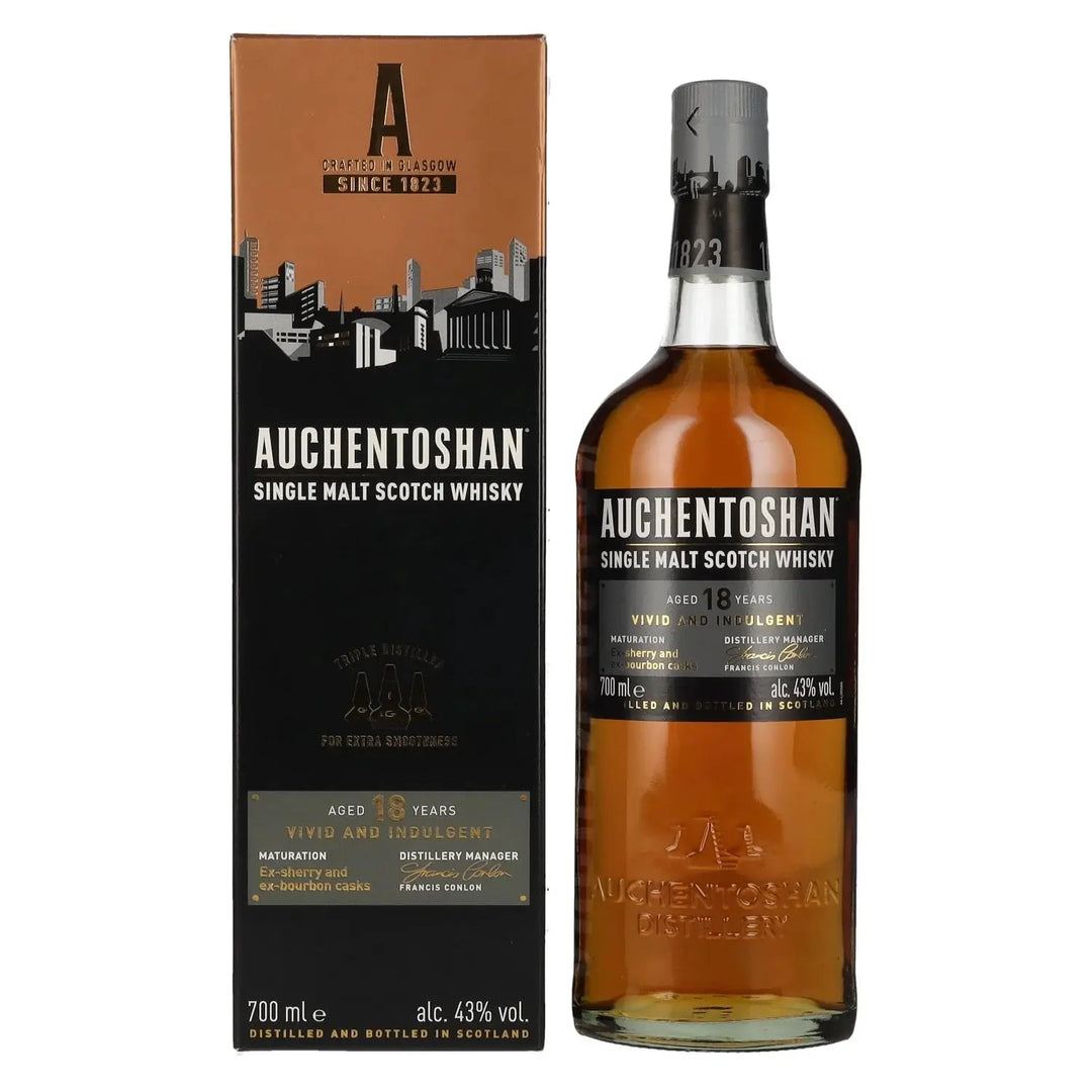 A bottle of Auchentoshan 18 Year Old Single Malt Scotch Whisky 700mL stands next to its black and orange box, both prominently featuring the Auchentoshan brand name and product details.