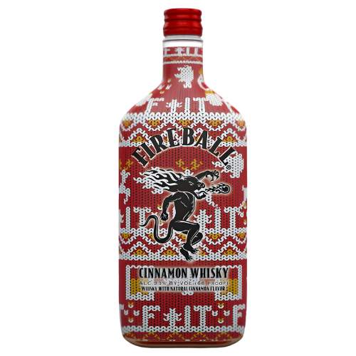 A bottle of Fireball Cinnamon Whisky Holiday Collector’s Edition Limited Release showcases a festive red and white sweater pattern, the Fireball brand logo, and a black dragon emblem on the front label.