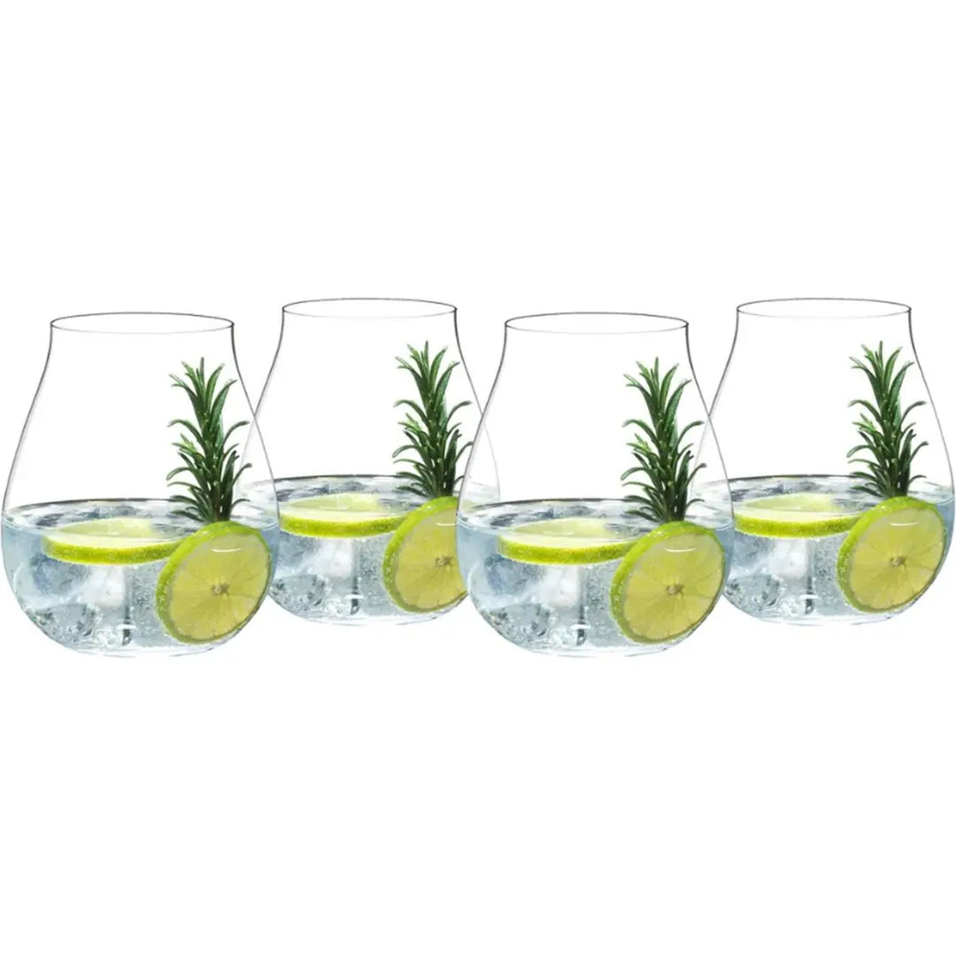 Four Riedel Gin glasses from the Riedel Gin Set of 4 are filled with ice, water, lime slices, and sprigs of rosemary, arranged in a row to evoke the elegance of this classic cocktail set.