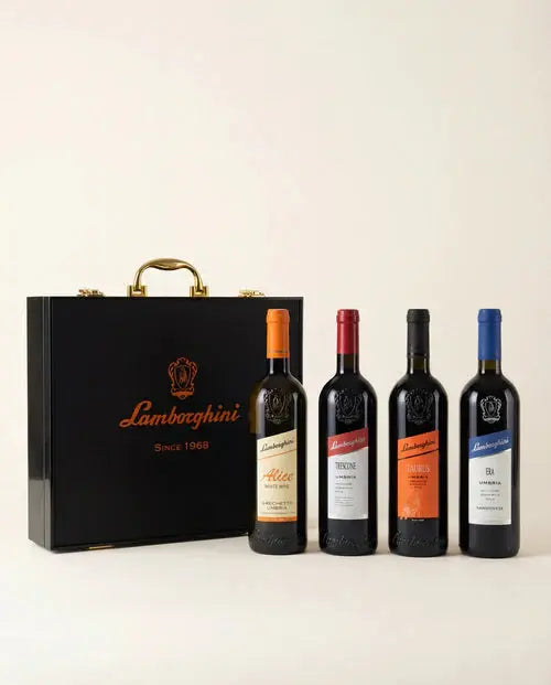 The Lamborghini Ultimate Wine Gift Set—Trescone, Era, Taurus, and Alice—by Lamborghini Wine &amp; Spirits Collections features four labeled bottles and a luxury black gift case with gold accents, perfect for any elegant wine gifting occasion.