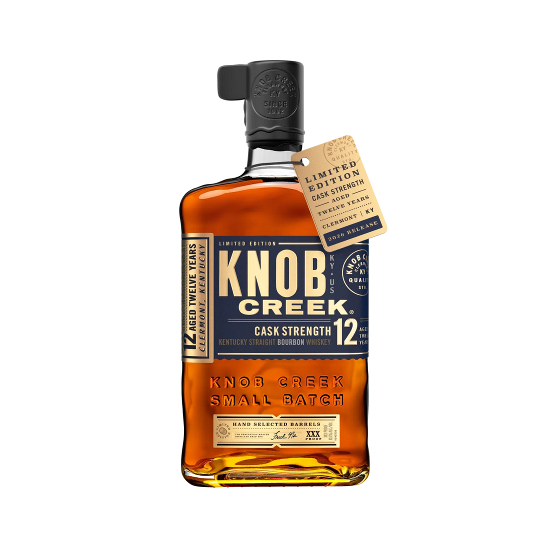 A bottle of Knob Creek 12 Year Old Cask Strength Kentucky Straight Bourbon, adorned with a limited edition tag hanging from the neck.