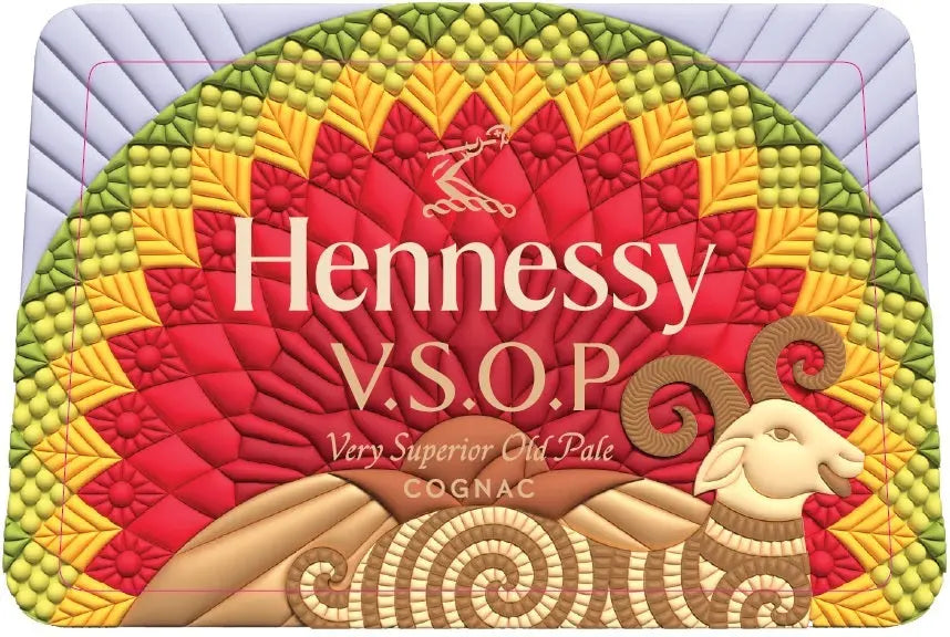 A vibrant mosaic artwork features a stylized ram with red, yellow, and green elements on the Hennessy V.S.O.P Year of the Fire Goat Lunar New Year by Raxxy Cognac Limited Edition collector's bottle.