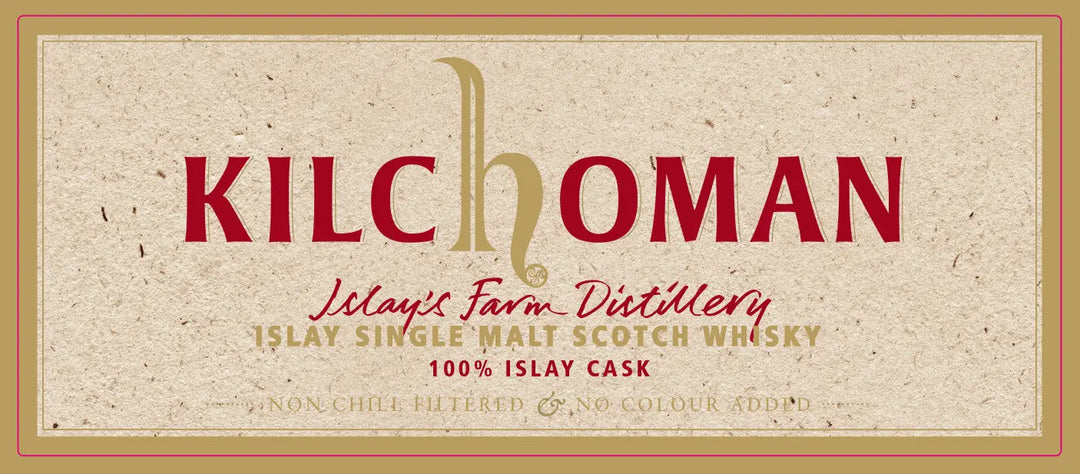 A beige Kilchoman label with red and gold text reads: Kilchoman 10 Year Old 100% Islay Cask Bourbon Single Cask Scotch Whisky, Islay’s Farm Distillery, Non-Chill Filtered & No Colour Added.