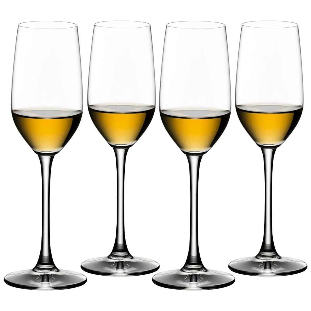 Four clear Riedel Tequila Set of 4 Sniffer Glasses, each partially filled with a golden-yellow liquid, are arranged side by side on a white background, perfectly showcasing the vibrant hue of premium tequila.