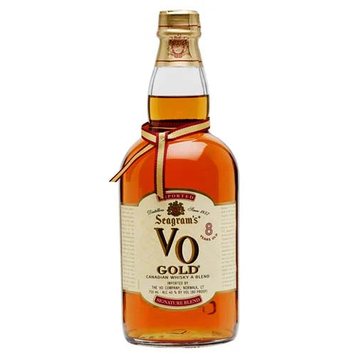 A bottle of Seagram's VO Gold 8 Year Old Canadian Whisky features a gold cap, beige label, red and gold neck ribbon, and displays the Seagram's V.O. name, highlighting its smooth 8-year aging.
