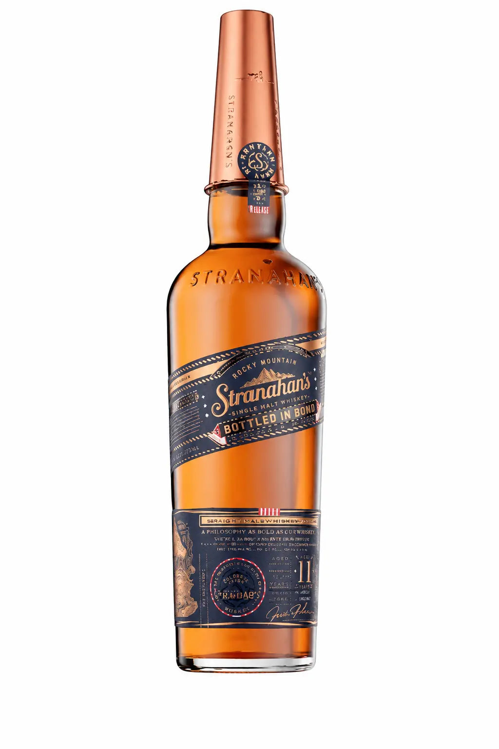 A bottle of Stranahan’s Bottled in Bond 11 Year American Single Malt Whiskey features a copper cap and a dark blue label prominently marked “Bottled in Bond.” The amber-colored whiskey is presented with a gold and navy design, accented by small text and graphics that emphasize its distinguished 11-year aging.
