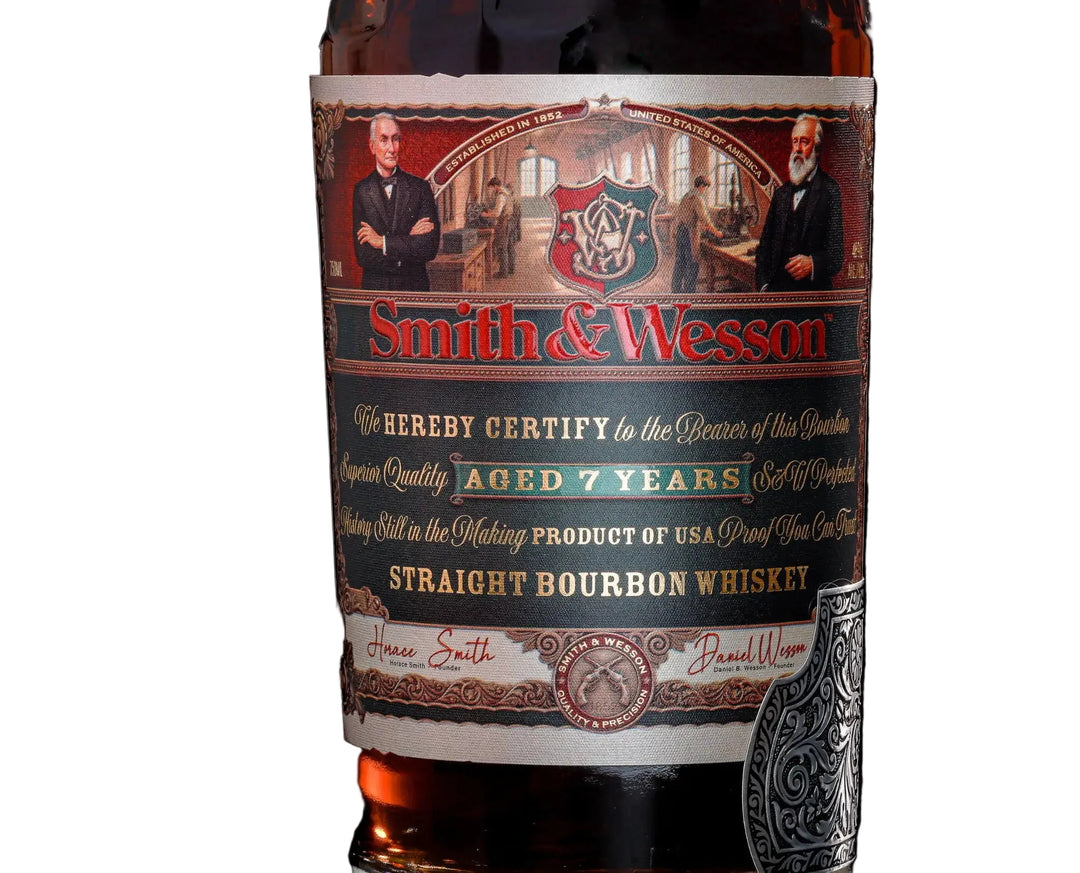 Close-up of a Smith &amp; Wesson 7 Year Straight Bourbon Whiskey label, featuring portraits, a crest, and gold, red, and green text emphasizing its status as an American whiskey aged 7 years.