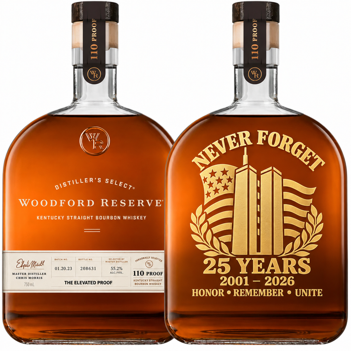 Two bottles of Woodford Reserve are displayed: one shows the standard label, while the other is the Woodford Reserve 110 Proof 9/11 Never Forget 25th Anniversary Memorial Edition. This commemorative bottle features a gold tribute with twin towers, an American flag, “Never Forget 25 Years 2001-2026,” and the words Honor Remember Unite. Hand-painted and crafted at 110 Proof, this unique edition from Woodford Reserve serves as both a heartfelt memorial and a collector’s item.